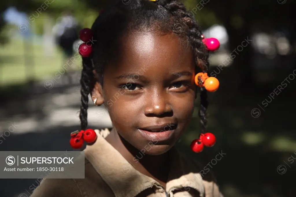 Dominican Republic, Samana Peninsula, Cayo Levantado, Barcardi Island  Portrait Of Local School Girl With Coloured Beads In Her Hair.