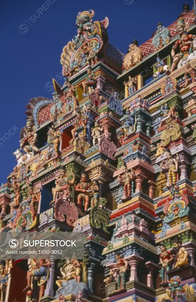 India, Tamil Nadu, Madurai, Sri Meenakshi Temple Detail Of Brightly Coloured Gopuram Exterior Wall Carvings