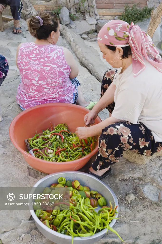 Turkey Aydin Province Sirince, Women preparing red and green chilies outside  in the old town