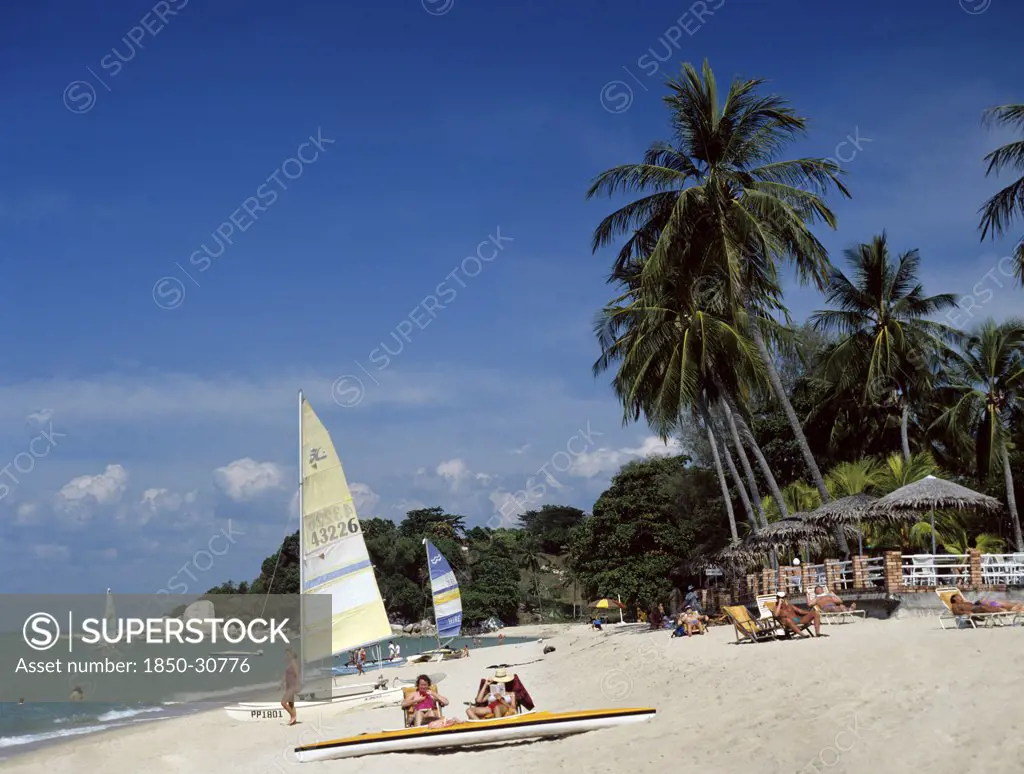 Malaysia Penang Batu Ferringhi, Beach scene with tourists sunbathing