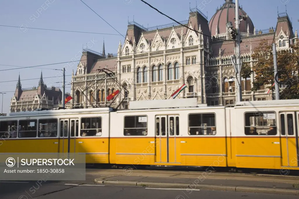 Hungary Pest County Budapest, Yellow tram passing the Parliament Building