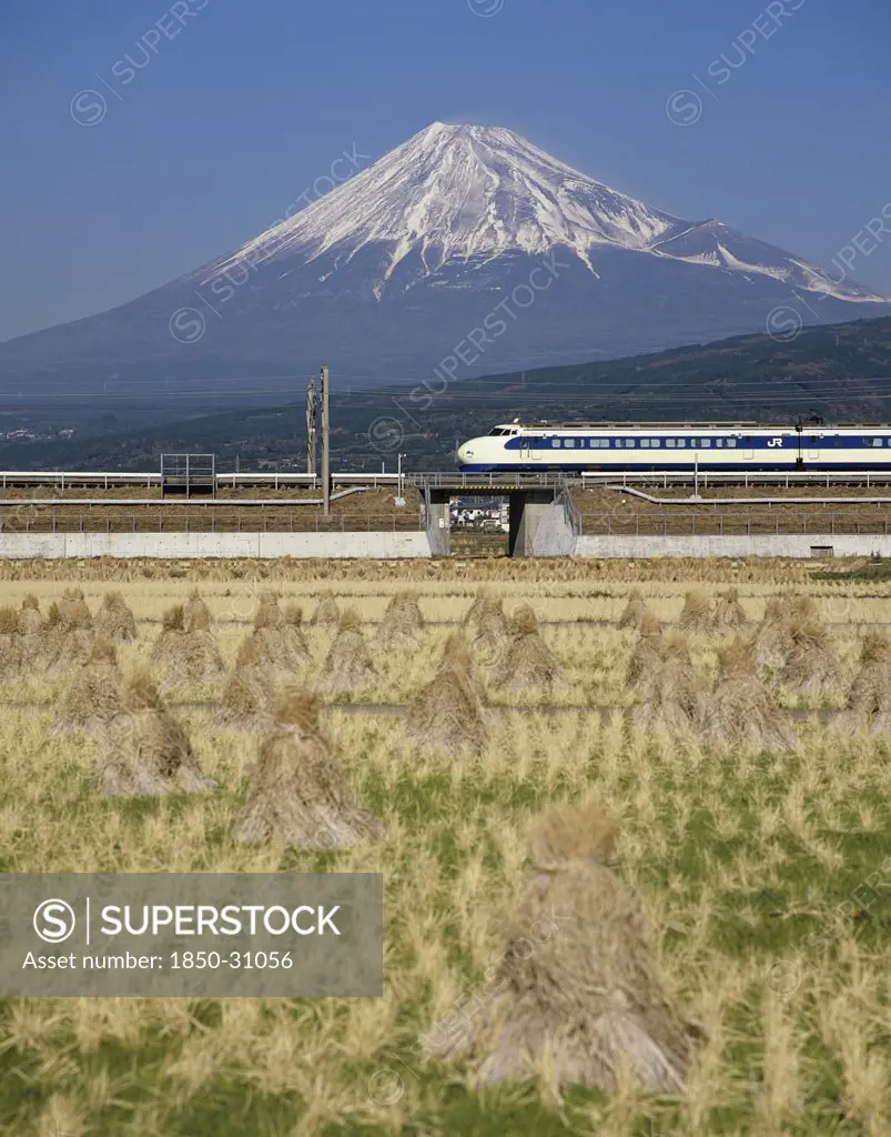 Japan Honshu Mount Fuji, Mount Fuji with Shinkansen bullet train passing through rice fields