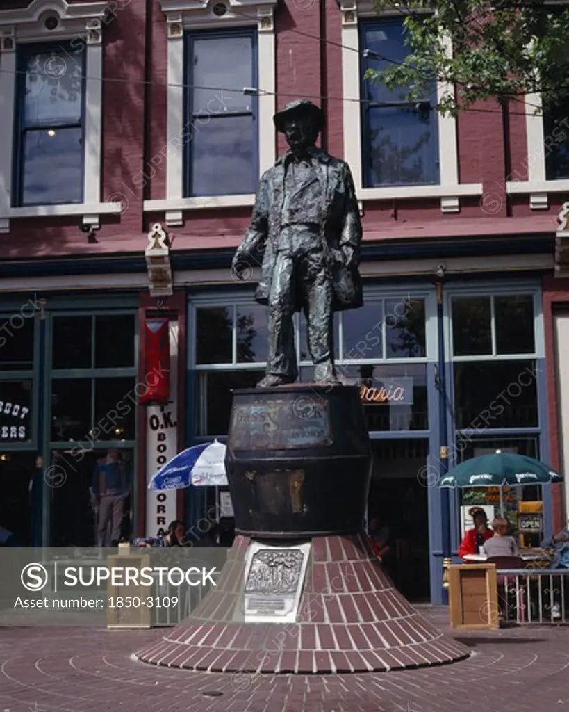 Canada, British Columbia, Vancouver, Gastown. Bronze Statue Of Gassy Jack The Father Of Gastown With A Cafe Behind