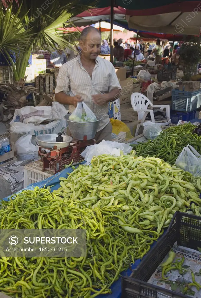 Turkey Aydin Province KUSAdasi, Turkish stallholder selling green chilis
