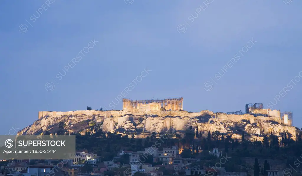 Greece Attica Athens, View towards the Acropolis on hilltop above Athens illuminated at dusk