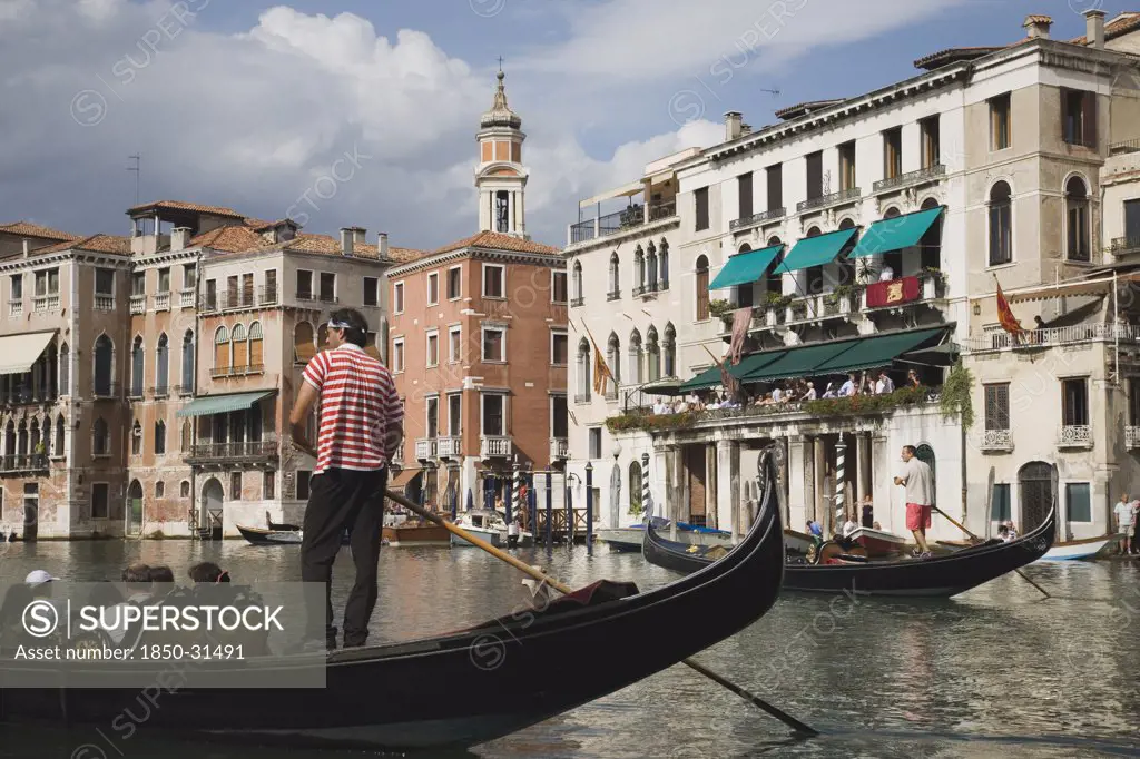 Italy Veneto Venice, Gondolier manoeuvres gondola before start of Regata Storico the Venice annual historical Regatta in September