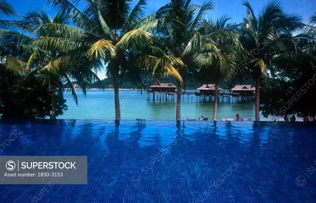 Malaysia, Pangkur, Laut  Sea Villas On Stilts Seen Over Blue Pool In The Foreground