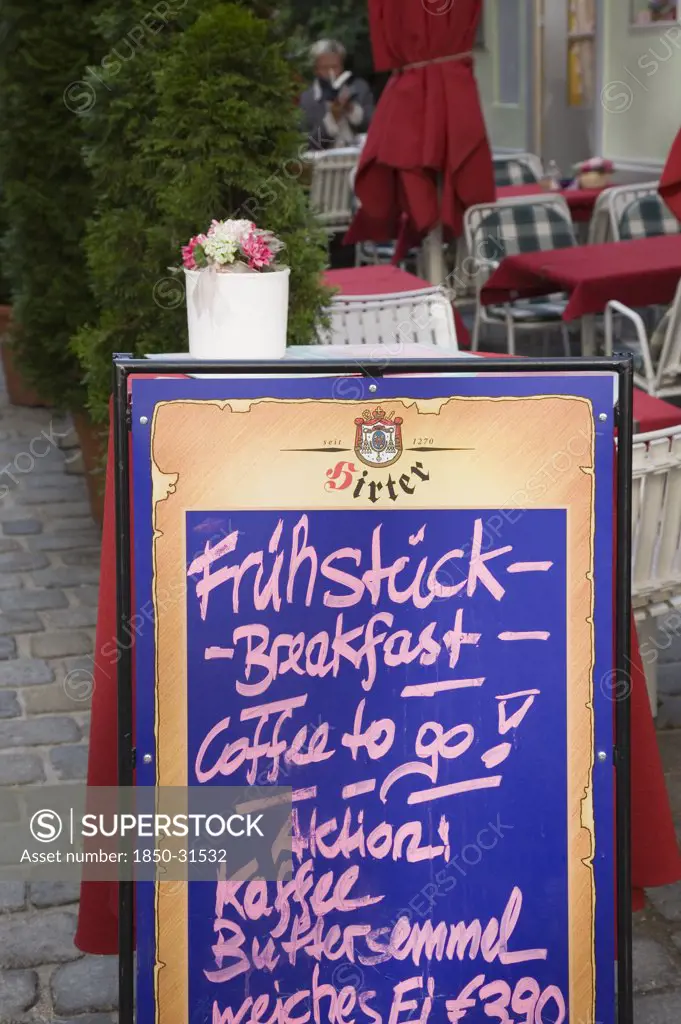 Austria Vienna, A board sign outside courtyard cafe advertising breakfast menu
