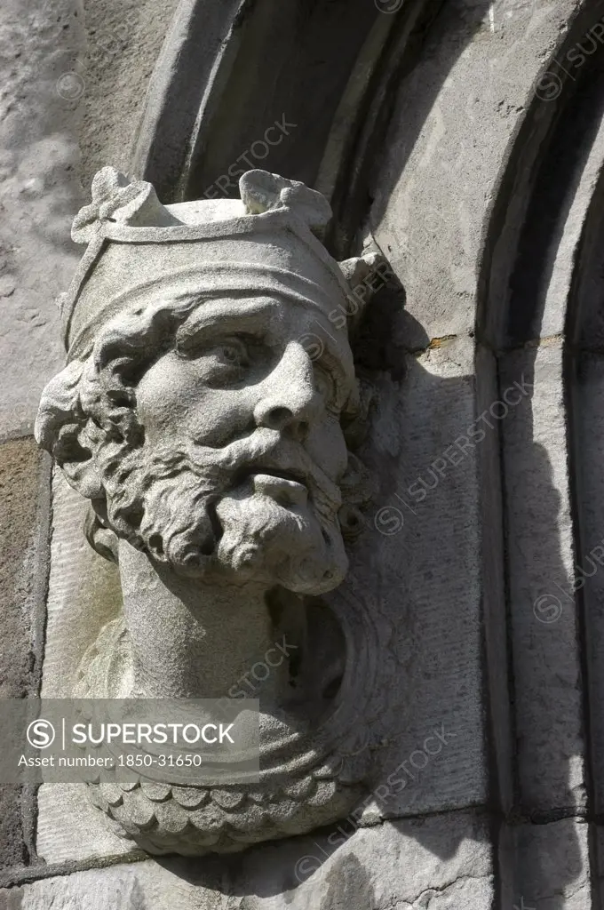 Ireland, Dublin, Crowned bearded face carved in stone on a building