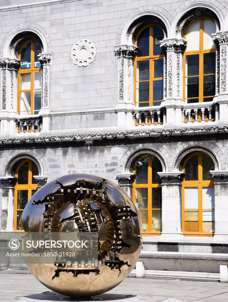 Ireland, County Dublin, Dublin City, Trinity College university Venetian Byzantine inspired Museum Building housing the Geology Department designed by Thomas Deane and Benjamin Woodward and built in 1853-57 and the sculpture Sphere Within Sphere by Arnaldo Pomodoro.