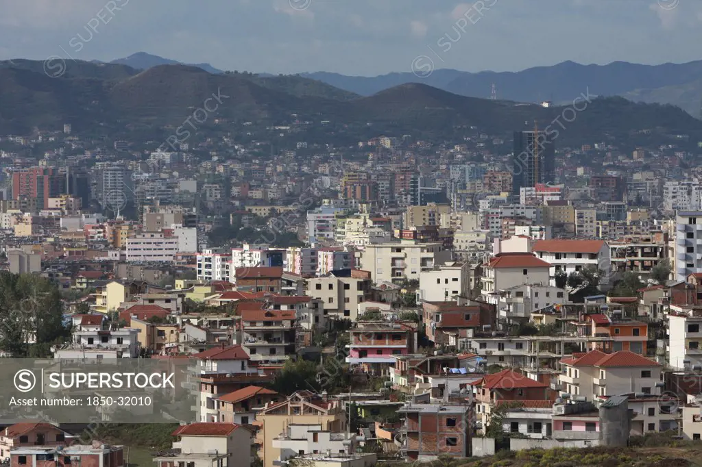Albania, Tirane, Tirana, View across residential buildings to the hillside beyond.