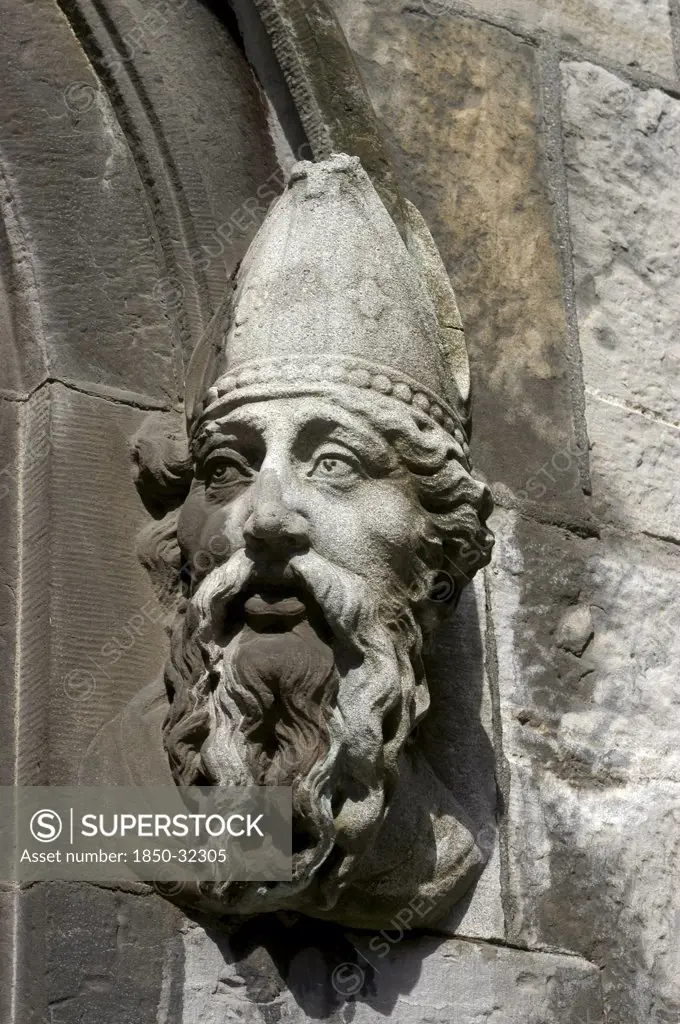 Ireland, Dublin, Building detail of a carved stone face depicting a bearded man