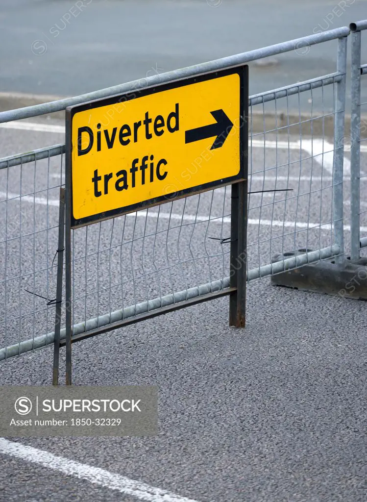 Transport, Road, Signs, Yellow Diverted Traffic diversion sign on barrier across empty urban road in Bognor Regis.