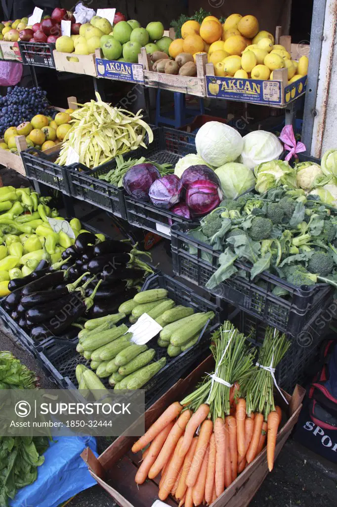 Albania, Tirane, Tirana, Display of fruit and vegetables including aubergines  carrots and cabbage at grocers in the Avni Rustemi market.