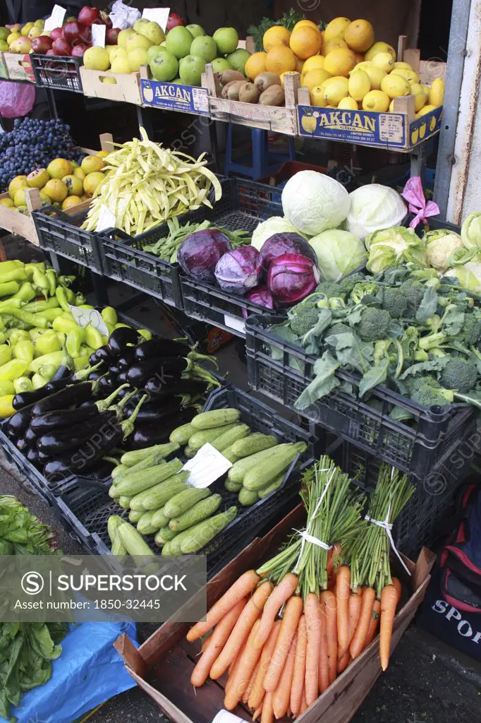 Albania, Tirane, Tirana, Display of fruit and vegetables including carrots  aubergine and cabbage at grocers shop in the Avni Rustemi market.