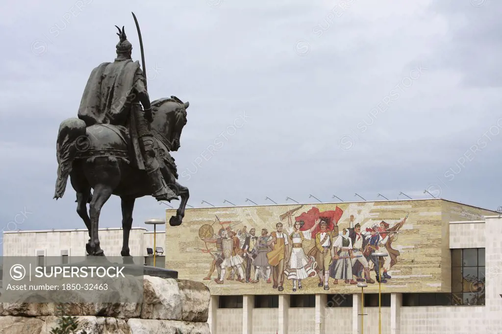 Albania, Tirane, Tirana, Equestrian statue of George Castriot Skanderbeg in Skanderbeg Square with the National History Museum exterior facade and mural beyond.