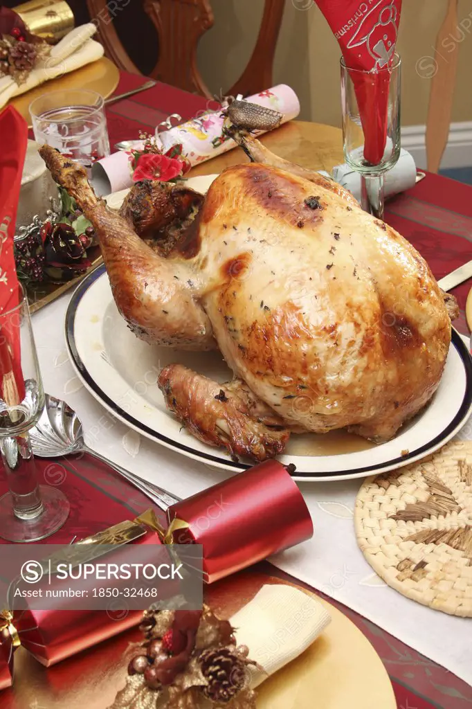Festivals, Religious, Christmas, Food  Cooked  Poultry. A whole turkey ready for carving on a table laid for Christmas lunch.