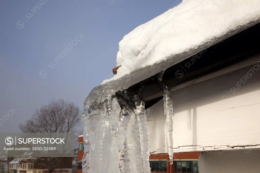 Weather, Winter, Ice, Large Icicle hanging from roof gutters.