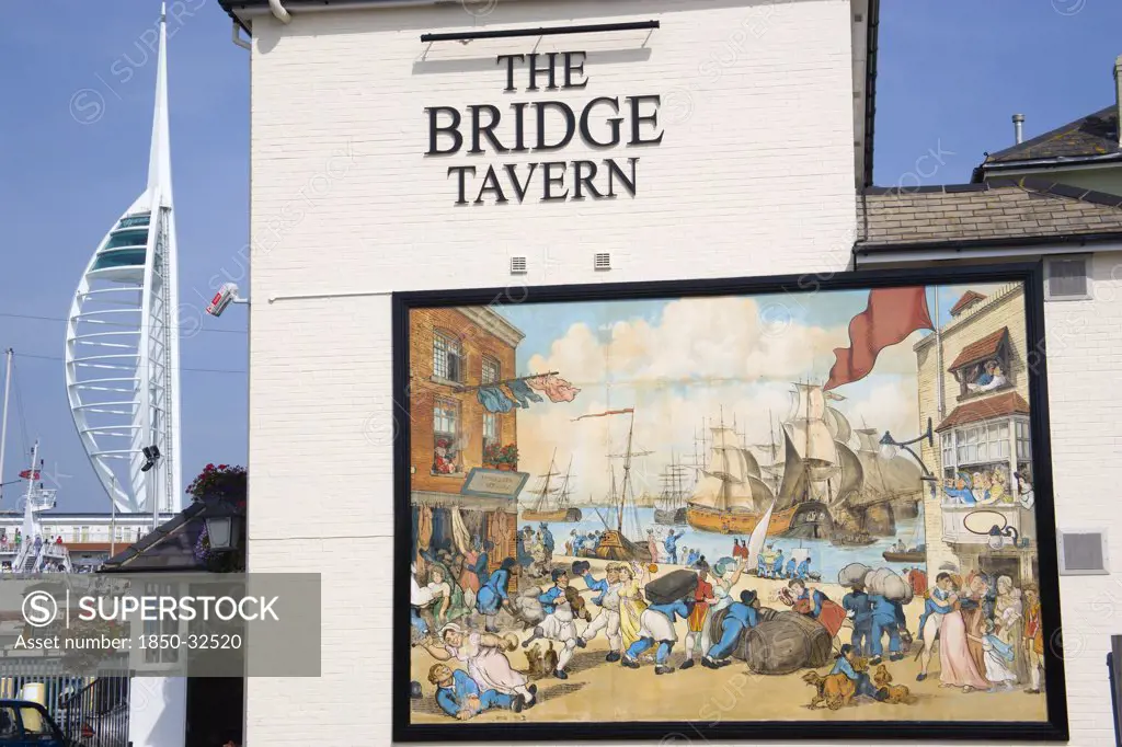 England, Hampshire, Portsmouth, The Camber in Old Portsmouth showing the Spinnaker Tower beyond the Bridge Tavern with a mural by Thomas Rowlanson of his cartoon entitled Portsmouth Point.