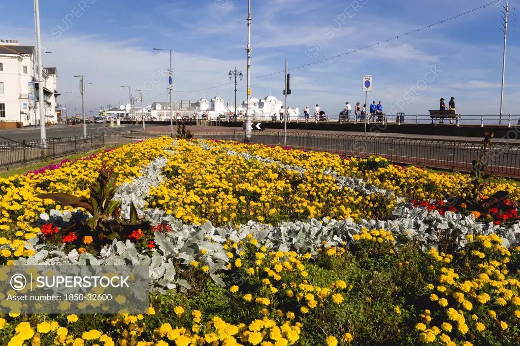 ENGLAND, Hampshire, Portsmouth, South Parade Pier built in 1908 on the seafront in Southsea with a floral garden display in foreground.