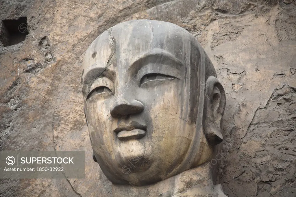 China, Henan Province, Luoyang, Carved Buddha statue in the Fengxian Temple, Tang Dynasty Longmen Grottoes and Cave.