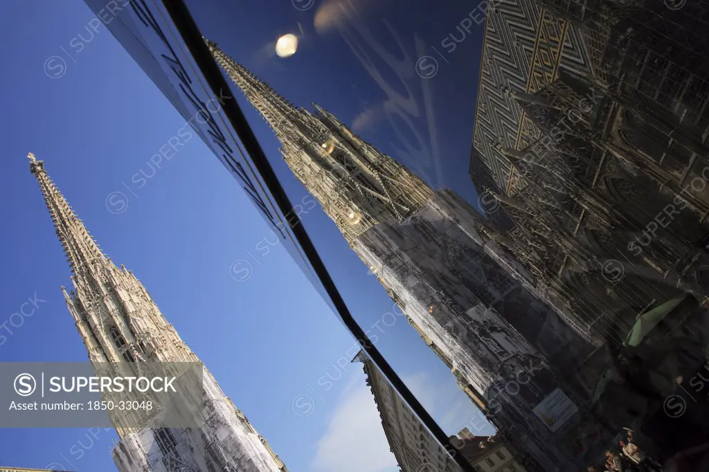 Austria, Vienna, Stephansdom Cathedral and its reflection in a shop window.