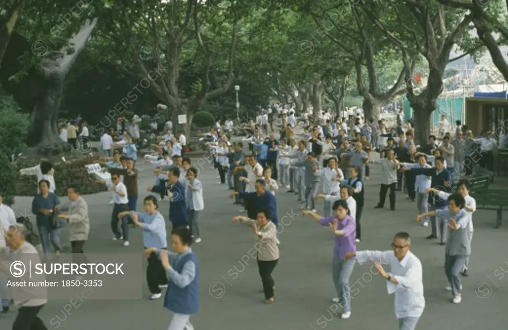 China, Shanghai, Group Of People Taking Part In Tai Chi Exercise
