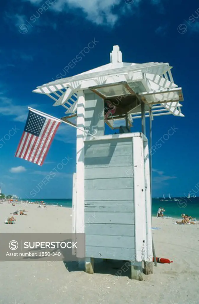 Usa, Florida , Fort Lauderdale, Lifeguard Tower On Beach With American Stars And Stripes Flag.