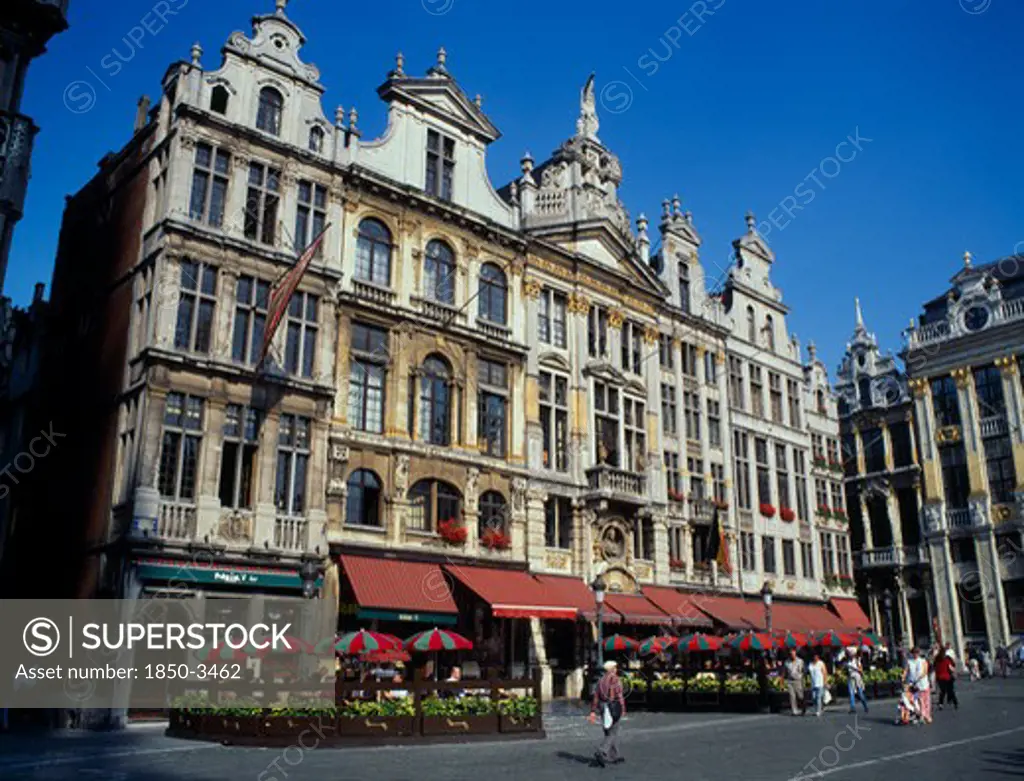 Belgium, Brussels, Grand Place, Highly Decorated Buildings In The Historic Square With Outdoor Restaurants And Umbrellas.