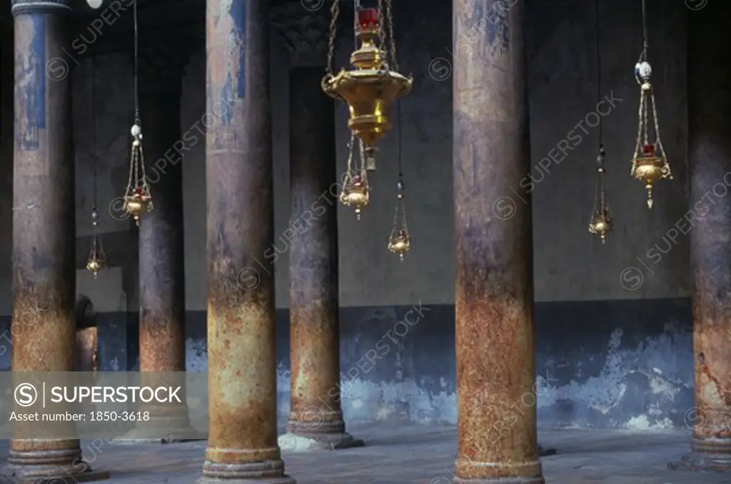 Israel,  , Bethlehem, The Church Of The Nativity Limestone Pillars With Candle Holders Hanging Down Between Them