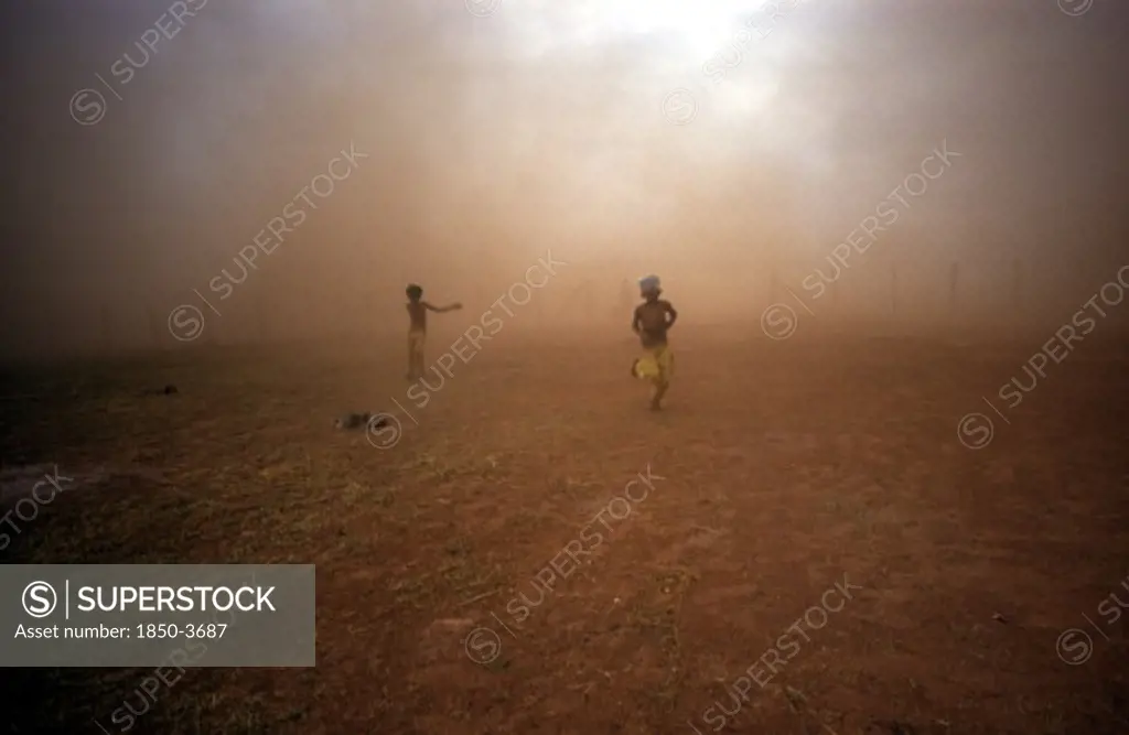 Cambodia, Military, Two Children Emerging From The Dust Cloud From A M: 26 Helicopter.