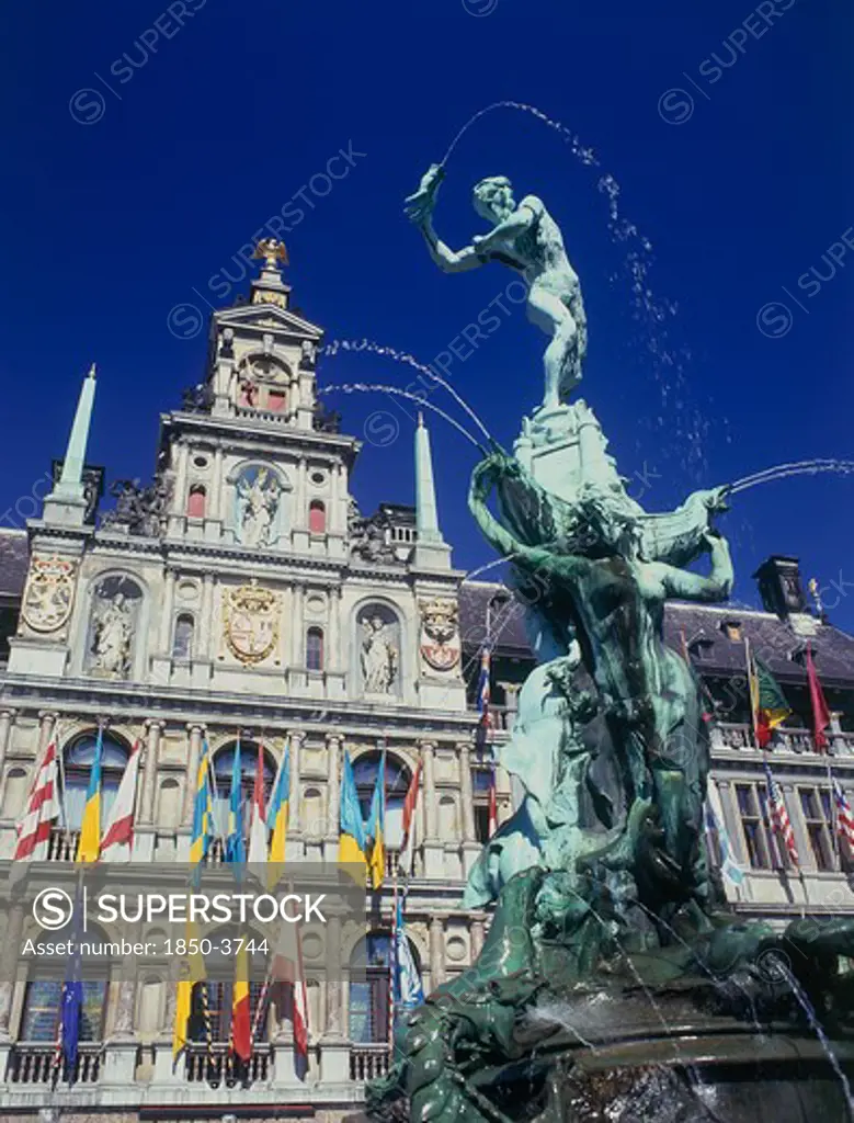 Belgium, Antwerp, Town Hall Facade Decorated With Flags And The Brabo Fountain In The Foreground