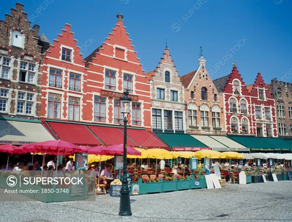 Belgium, West Flanders, Bruges, 'The West Side Of The Main Square, Grote Markt, With Outdoor Restaurants And Umbrellas '