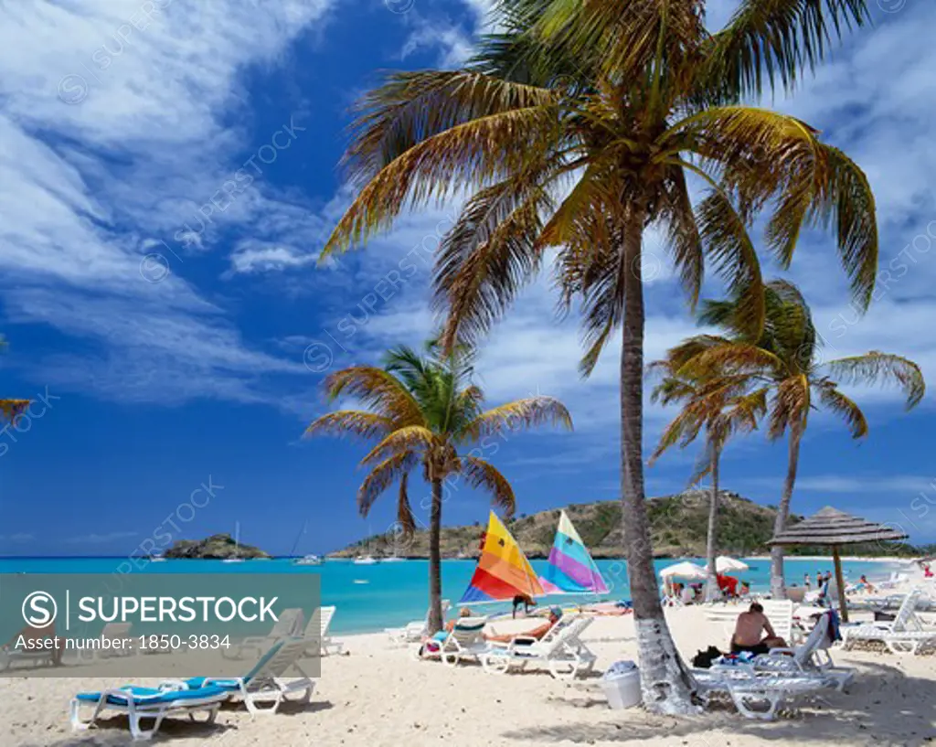 West Indies, Antigua, 'Deep Bay.  Sandy Beach With Sailing Boats, Sunbeds And Palm Trees. '
