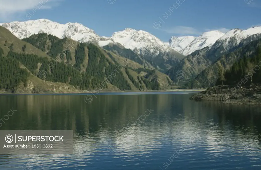China, Xinjiang , Lake Tianchi, View Over The Lake Toward Snow Capped Mountain Peaks