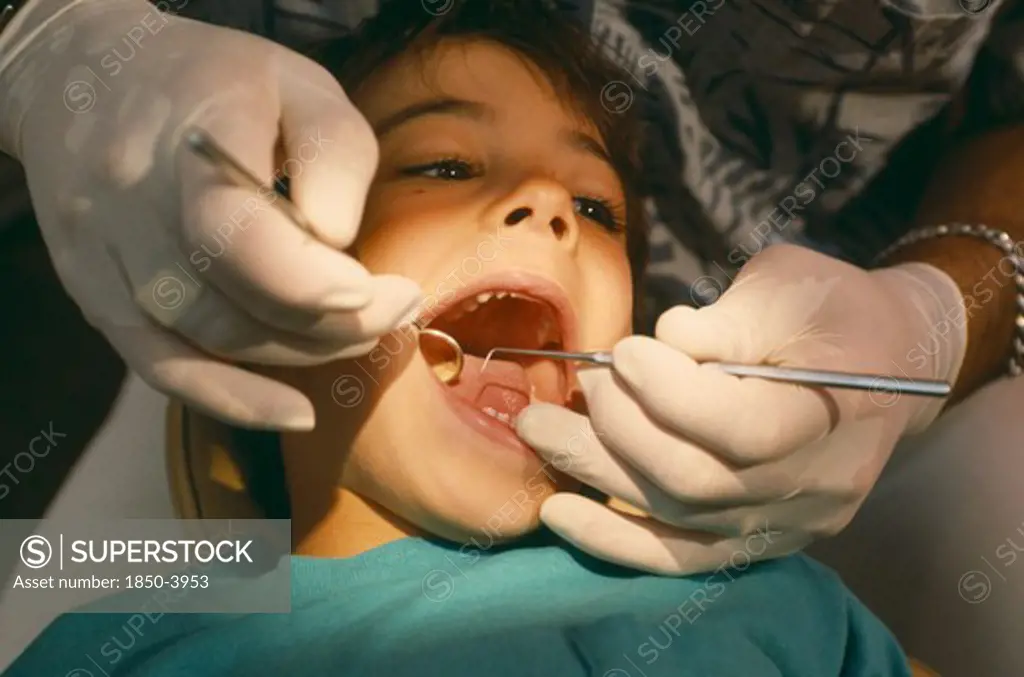 Health, Dentistry, Dentist Examining Child With Mouth Wide Open