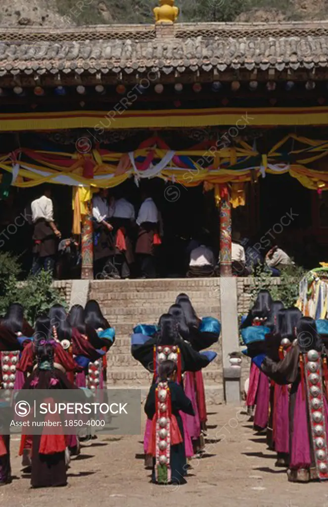 China, Guizhou, Tongren, Tibetan Festival At A Temple With Rows Of Girls In Traditional Costume Standing Before Steps