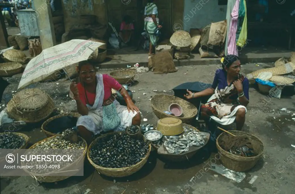 India, Goa, Margao, The Fish Market With Smiling Woman Holding Umbrella As A Sun Shade
