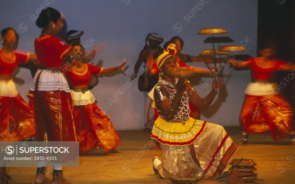 Sri Lanka, Kandy Dancers, Traditional Dancers And Man Spinning Plates On Poles And Fingers On Stage.