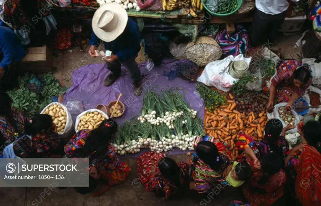 Guatemala, Chichicastenango , View Looking Down On Market Scene With People Sitting At A Vegetable Stall