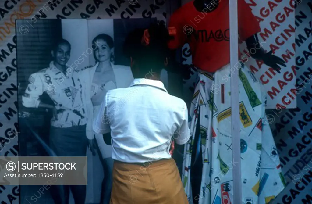 Cuba,  , Havana, School Girl Standing At Fashion Shop Window