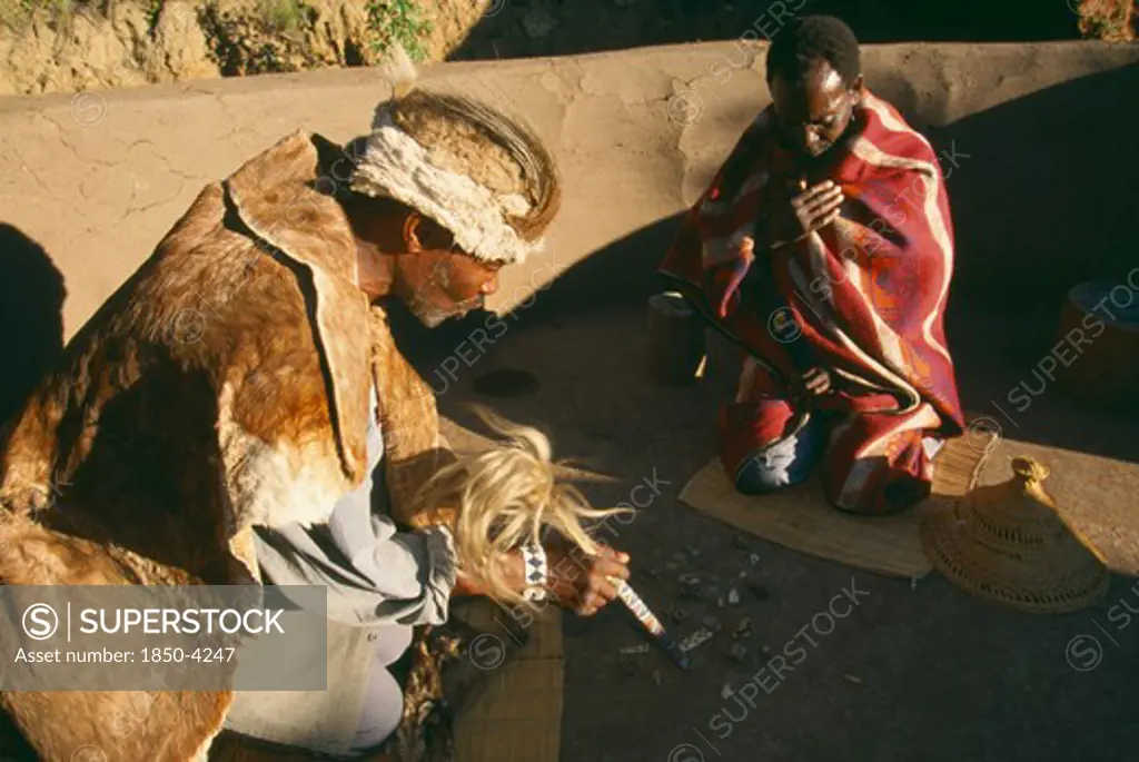 South Africa, Qwa-Qwa, Basotho Village, Basotho Cultural Village.  Local Man Consulting A Diviner Using Stones.