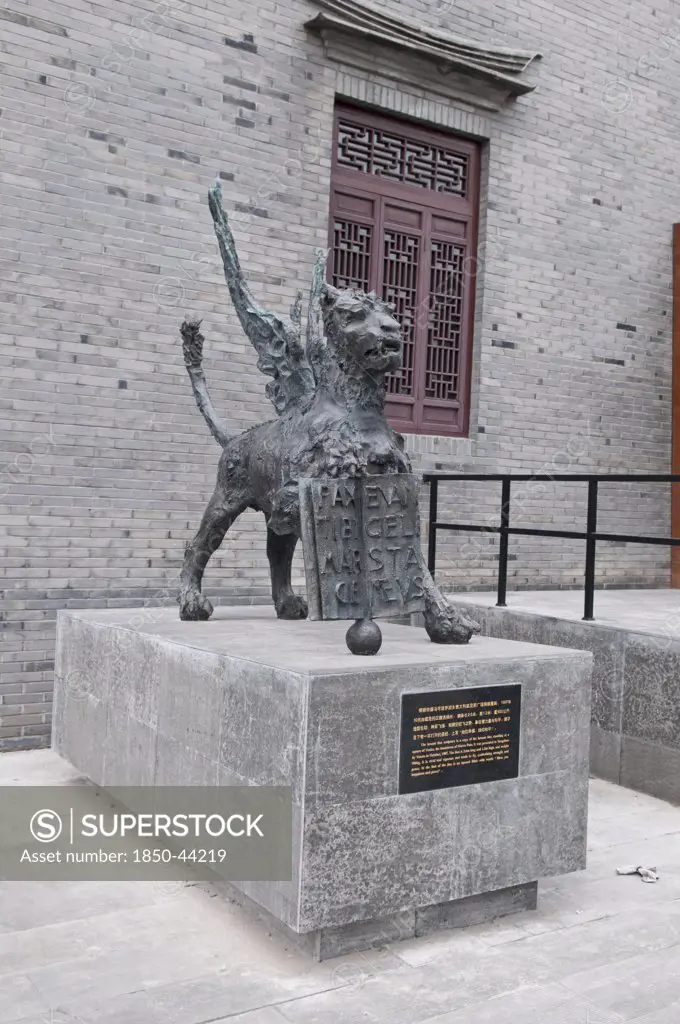China, Jiangsu, Yangzhou, Bronze lion sculpture outside the Marco Polo Museum. The sculpture is a copy of the lion statue standing in a square in Venice the hometown of Marco Polo. Marco Polo served as a municipal official of Yangzhou from 1282-1287 during the reign of the Mongol emporor Kubilai Khan.