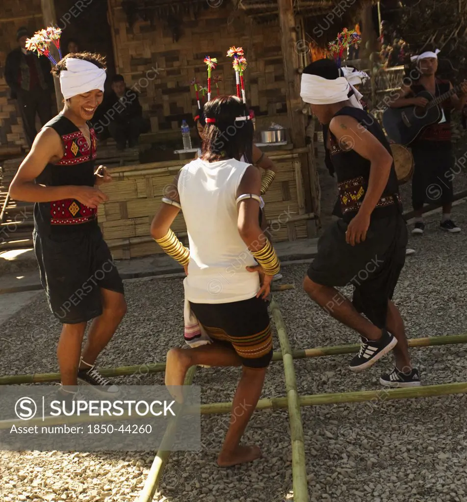 India, Nagaland, People, Naga Warrior tribe performing bamboo dance.