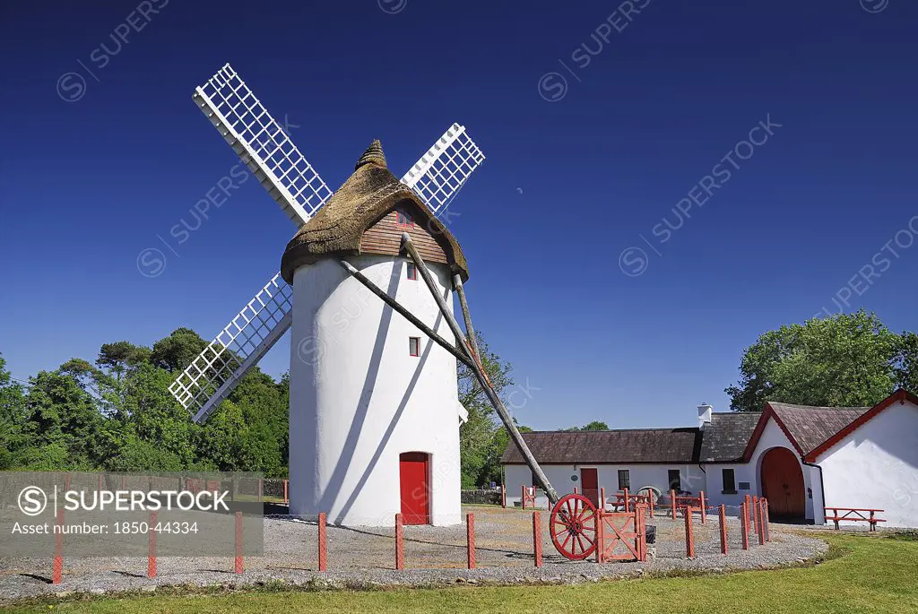 Ireland, County Roscommon, Elphin , Windmill. Painted white with red door. Built c.1730 and restored in 1996. Thatched rye rotating roof with four timber sails