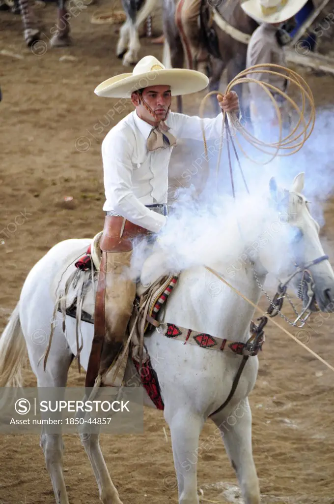 Traditional horseman or Charro competing in Mexican rodeo holding lasso.Mexico Bajio Zacatecas