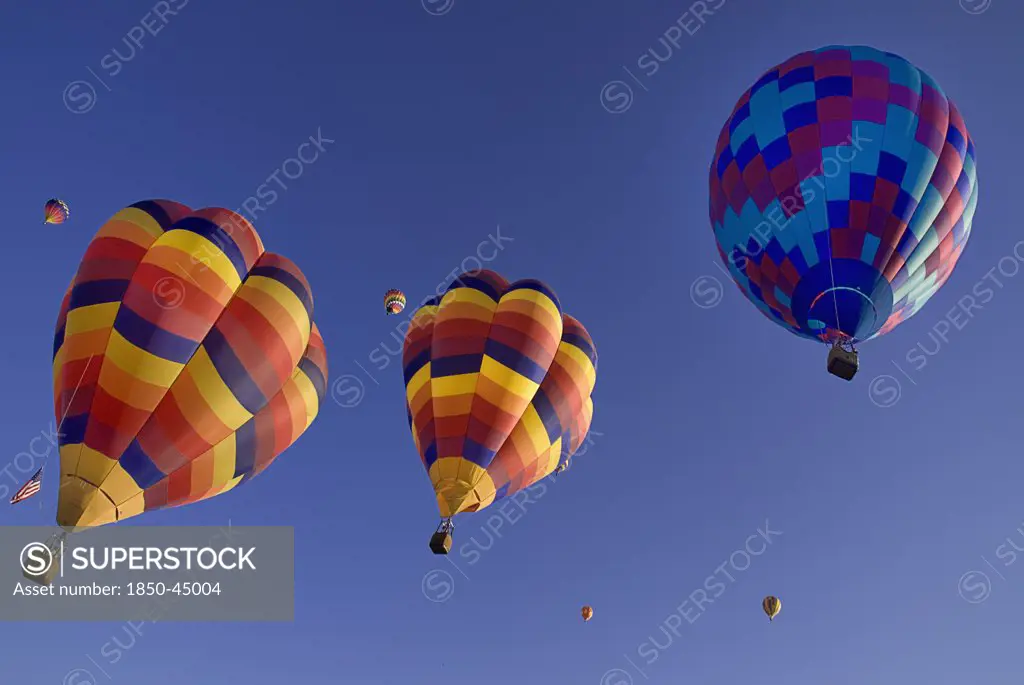 Annual balloon fiesta colourful hot air balloons ascending.USA New Mexico Albuquerque