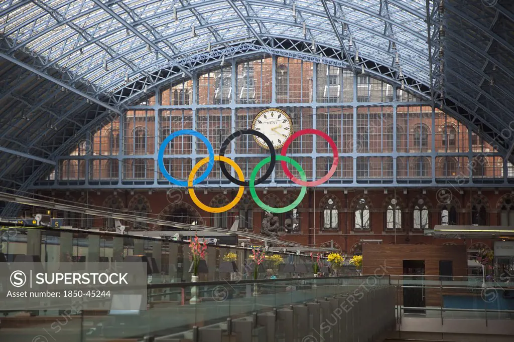 St Pancras railway station on Euston Road. View from champaigne bar along concourse towards the 2012 Olympic Games hanging sculpture and clock.England London