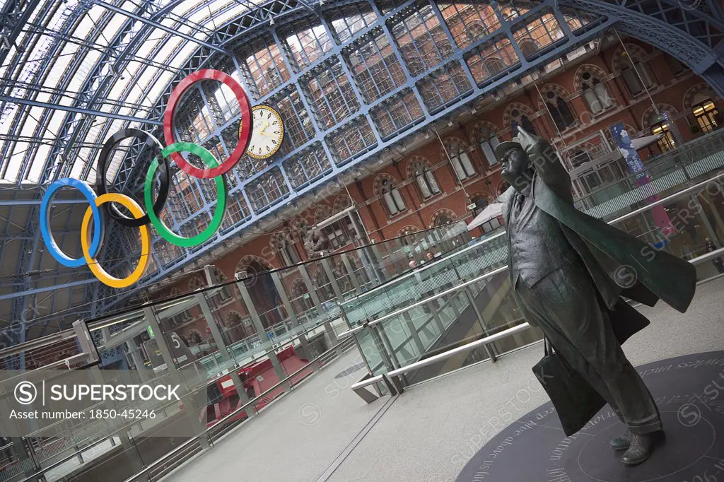 St Pancras railway station on Euston Road Statue of Sir John Betjeman. Olympic Games 2012 hanging sculpture.England London