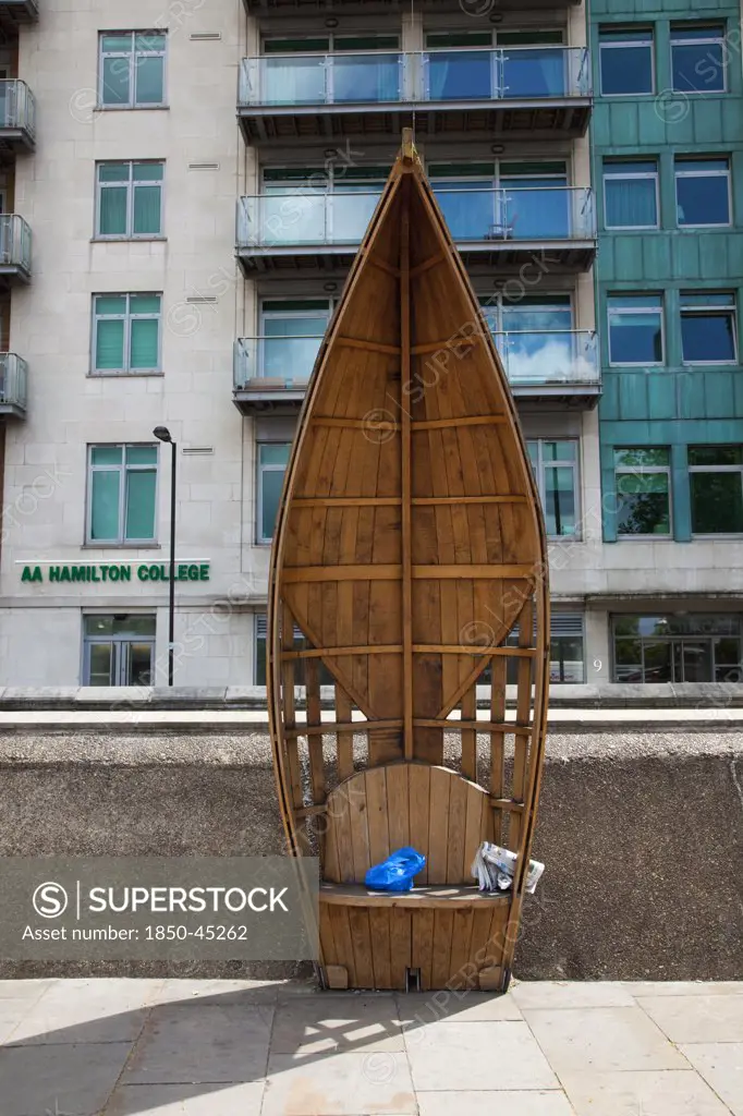 Vauxhall Albert embankment benches made from wood in the shape of boats, England London
